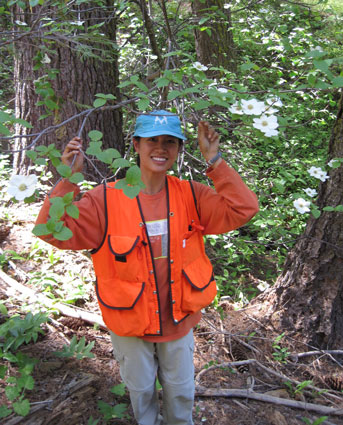 Jan Ng standing among trees