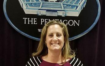 Jenna Gadberry poses in front of the Pentagon seal