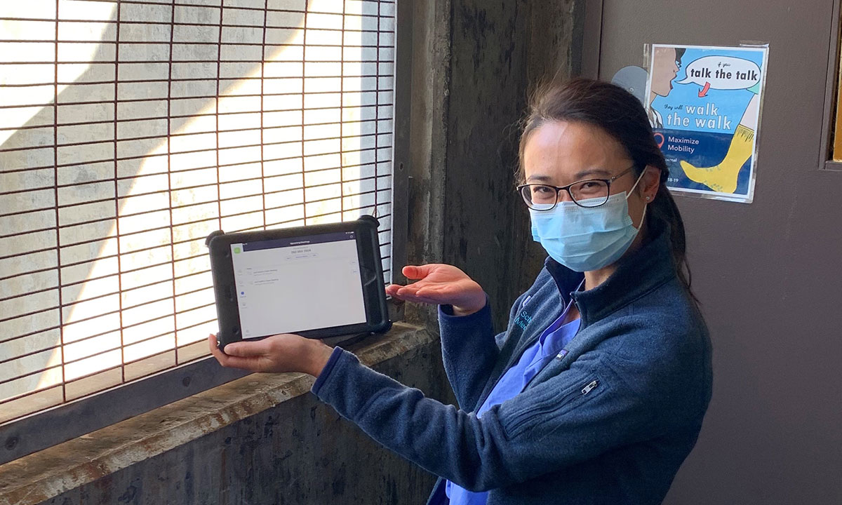 Medical resident holding tablet