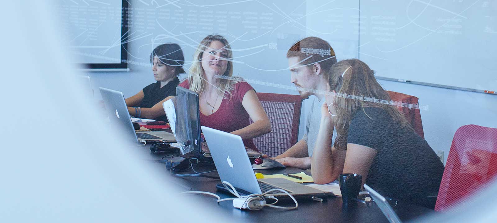 several people in a conference room working