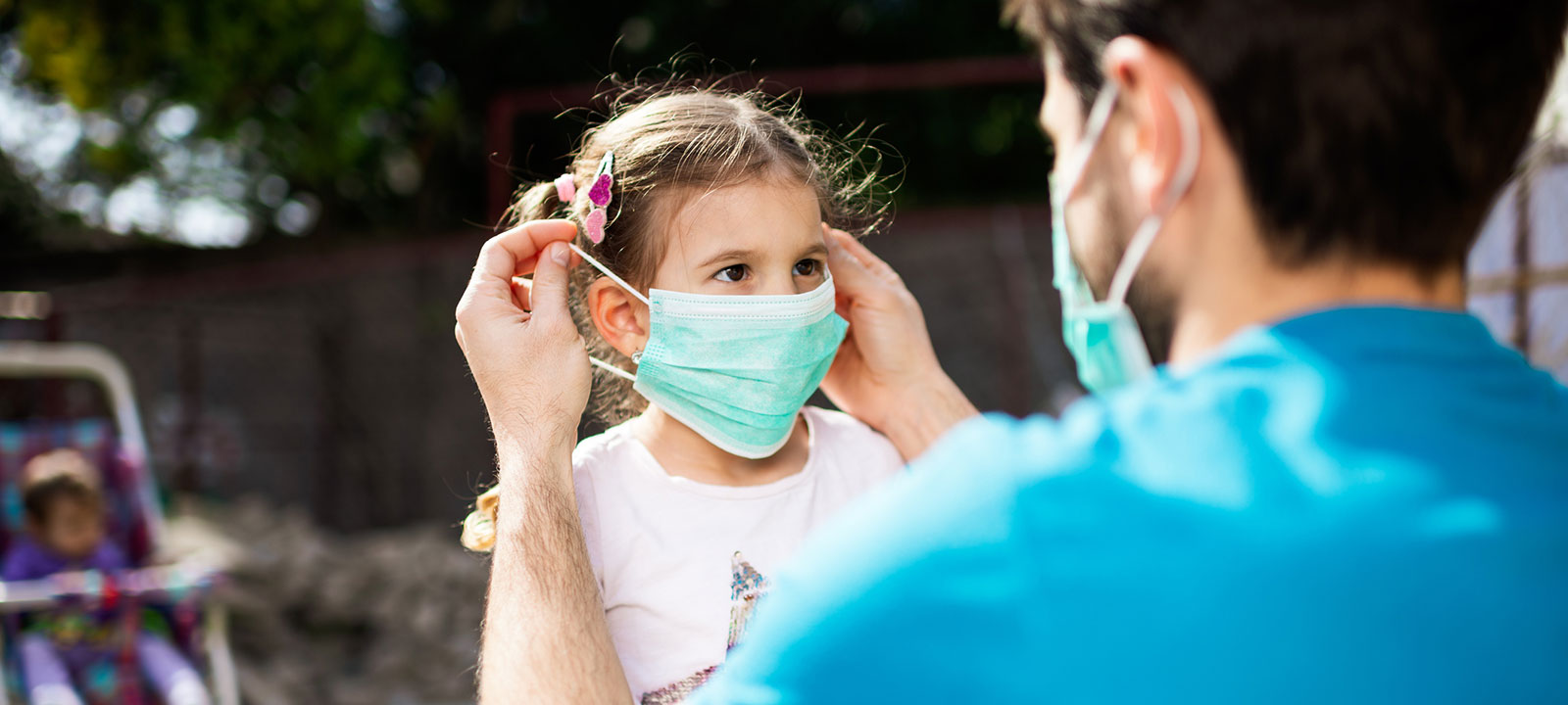 Man puts mask on child