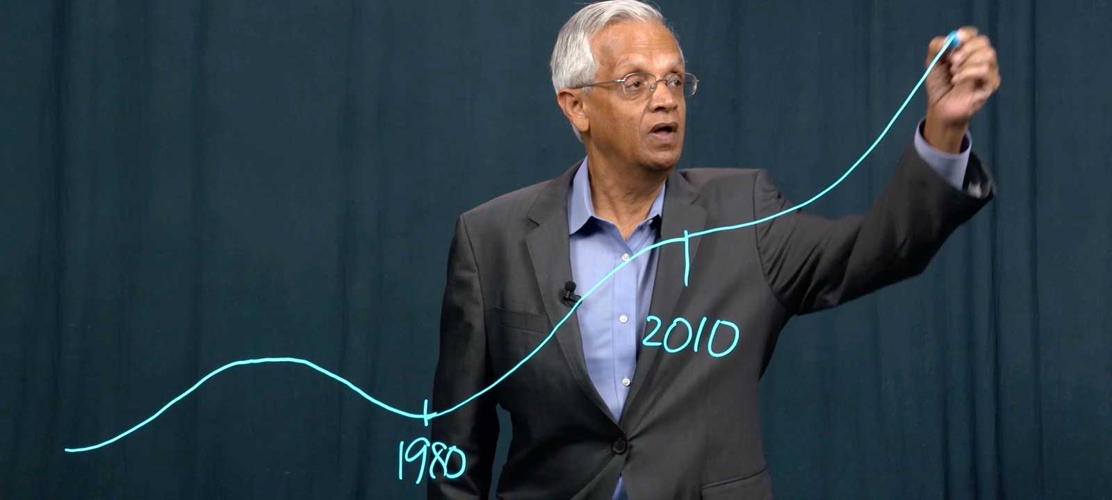 V. Ramanathan drawing a climate chart on a clear dry erase board 