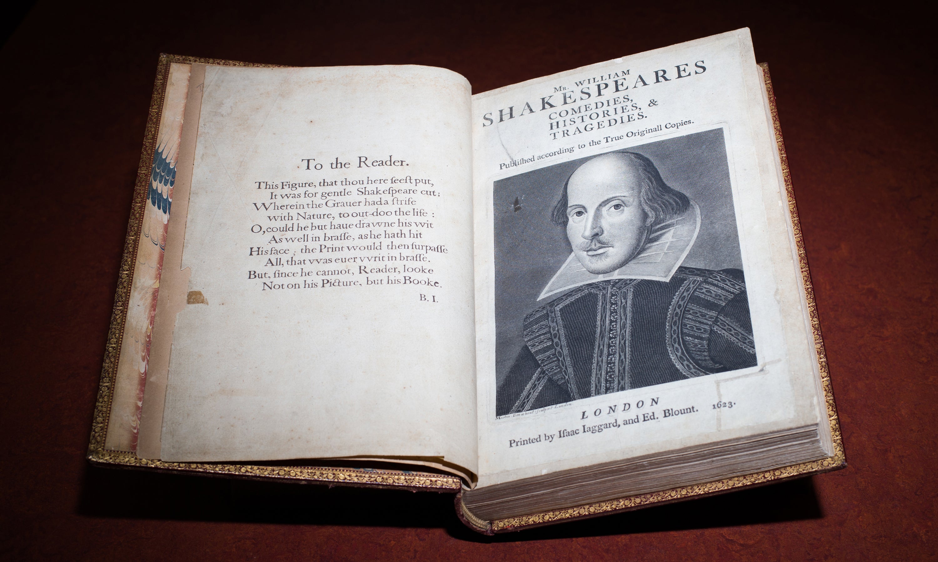 An old book open to a page showing a portrait of William Shakespeare