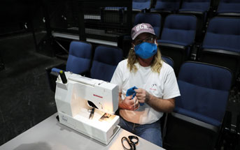 Alan Call sewing masks on a table