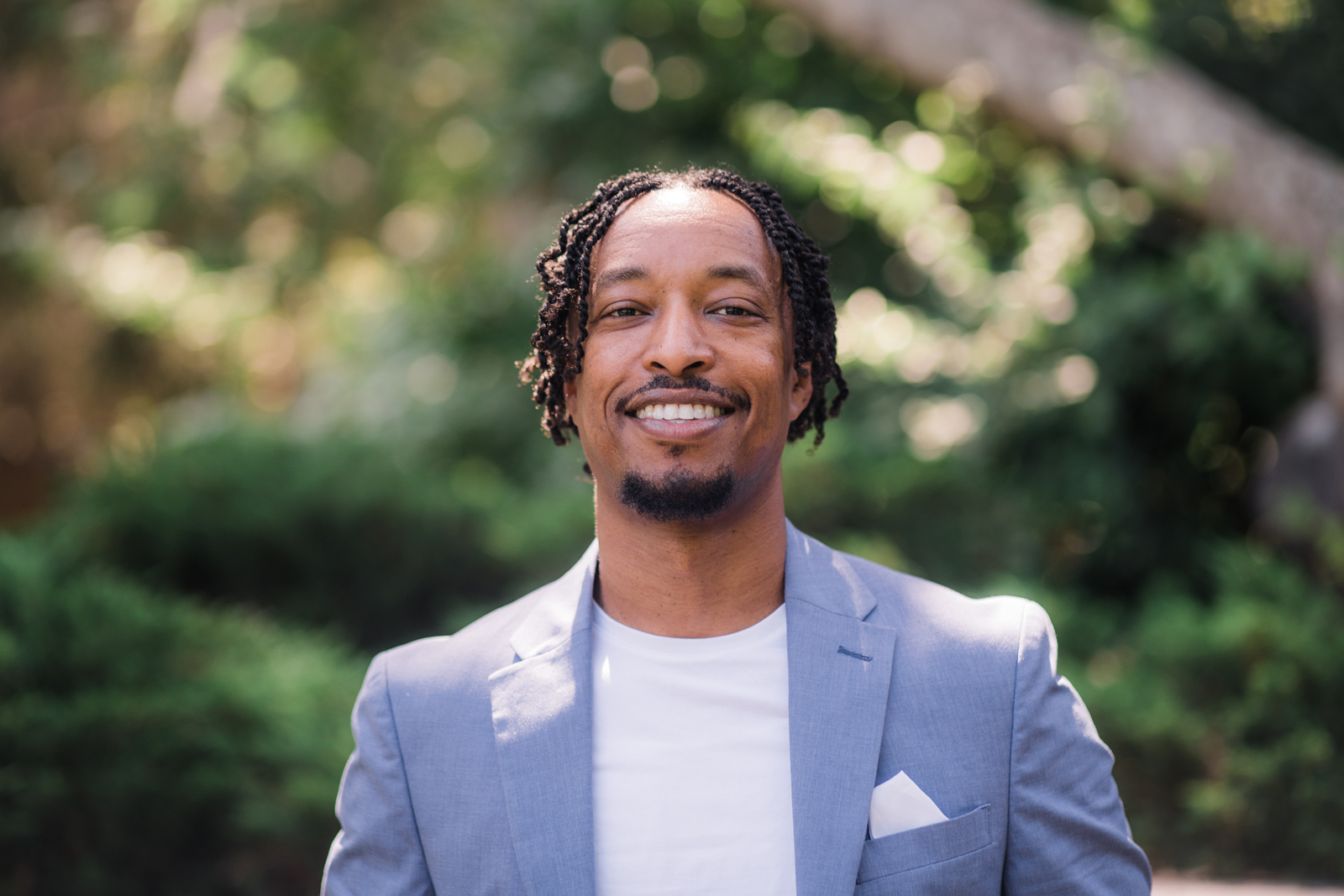 Smiling young Black man in a powder blue blazer, Merhawi Tesfai