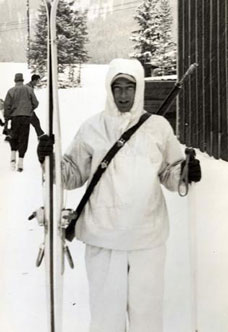 Milton holding skis at training base