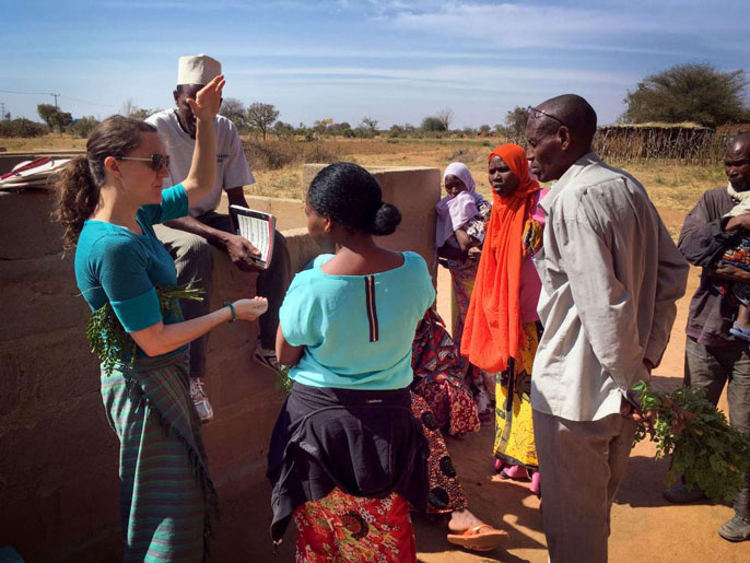 Carrie Waterman discusses moringa with locals in Singida, Tanzania.