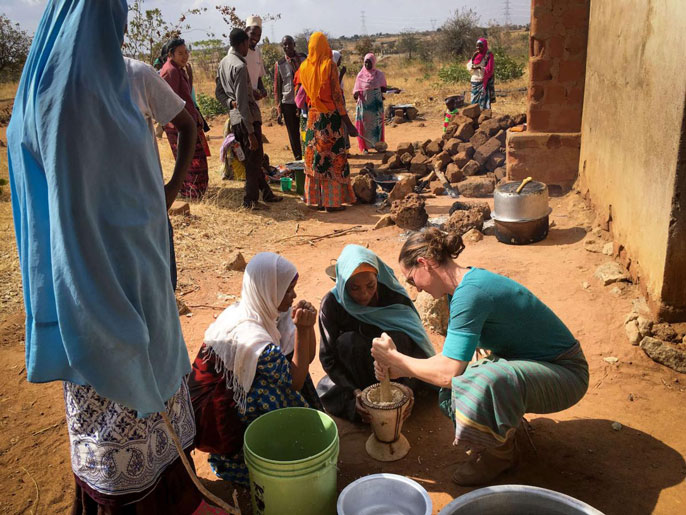 Carrie Waterman harvests moringa with locals