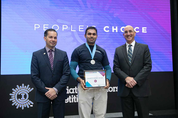 Tilvawala accepts the People's Choice Award at the Collegiate Inventors Competition