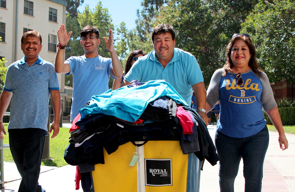 Pandey's family helps him roll a cart to his UCLA dorm