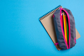 Pencils in a case on a blue background