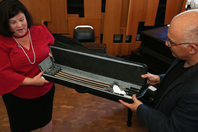 Lynn Running presents violin bows to Movses Pogossian