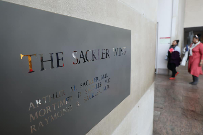 A sign hanging in the Metropolitan Museum of Art's Sackler Wing names all three brothers, Arthur, Mortimer and Raymond