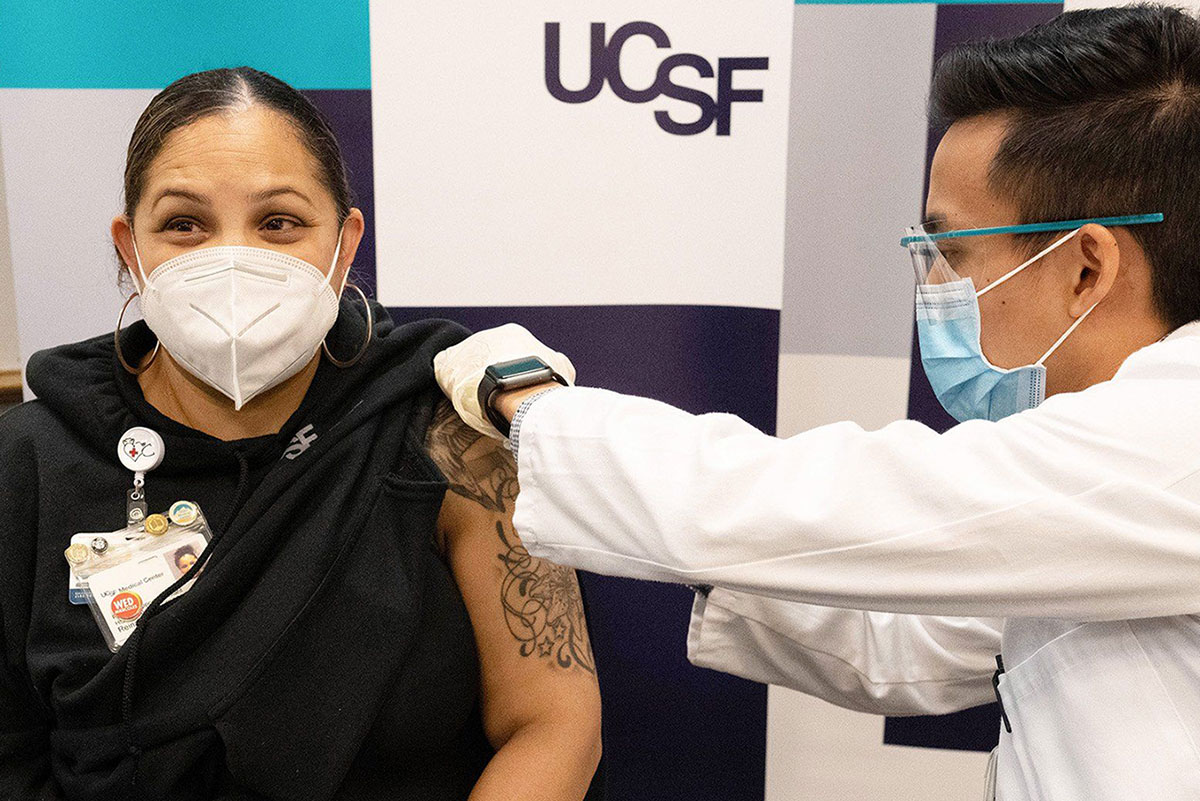 Woman excitedly getting COVID-19 vaccine