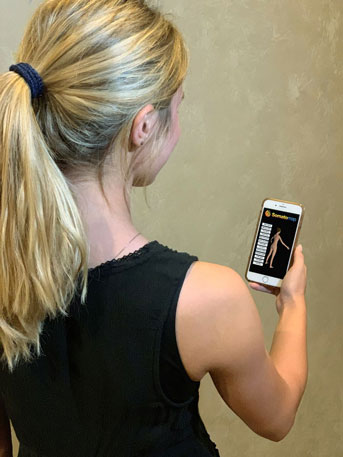 Woman holding the Somatomap app