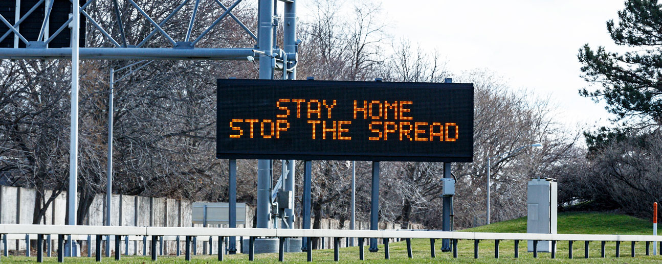 Stop the Spread on a highway sign next to an empty highway