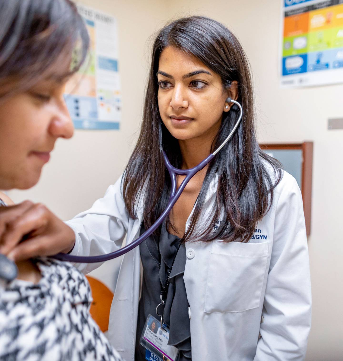 Woman doctor using a stethoscope on a patient
