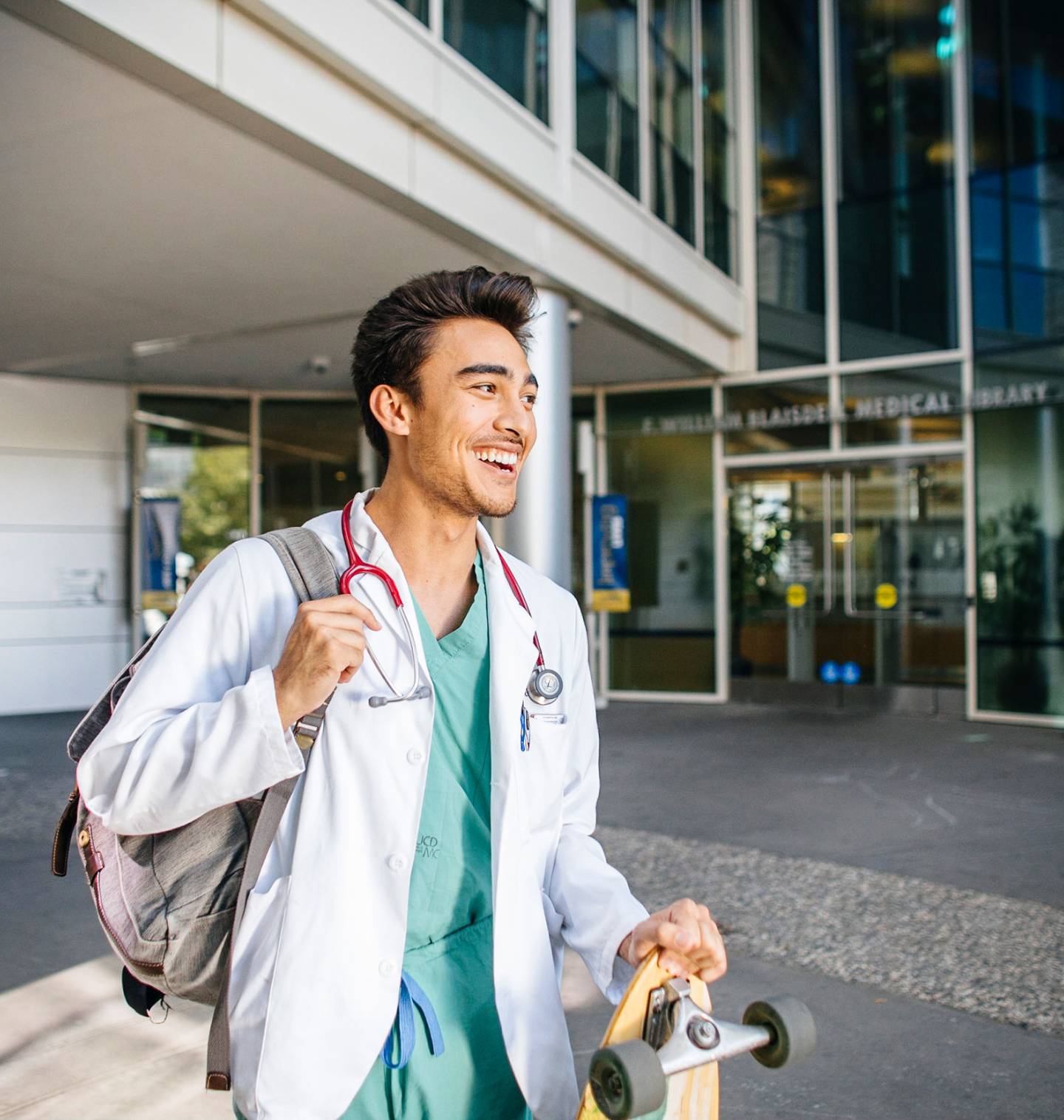 Medical student with backpack and stethoscope.