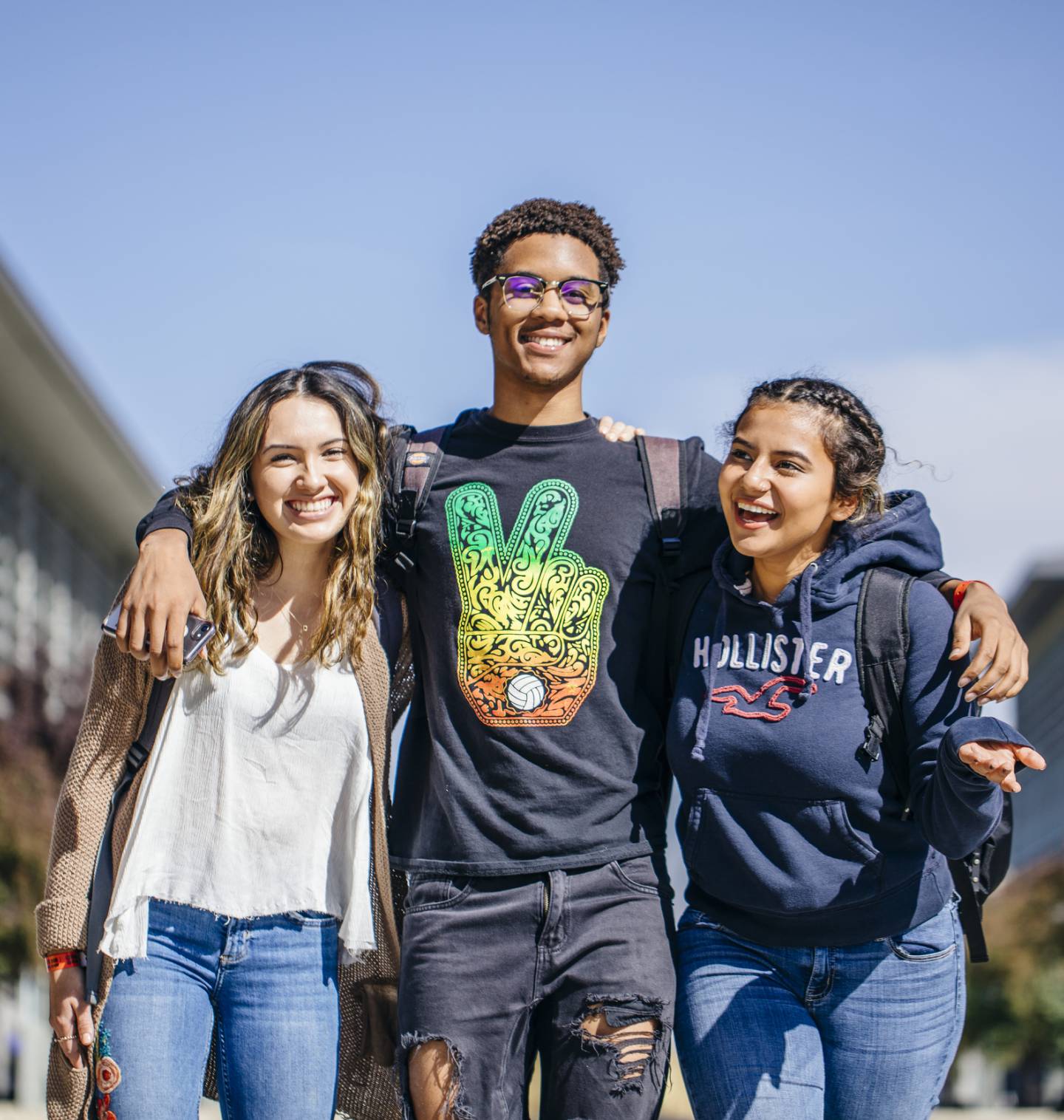 Three students walking together on campus