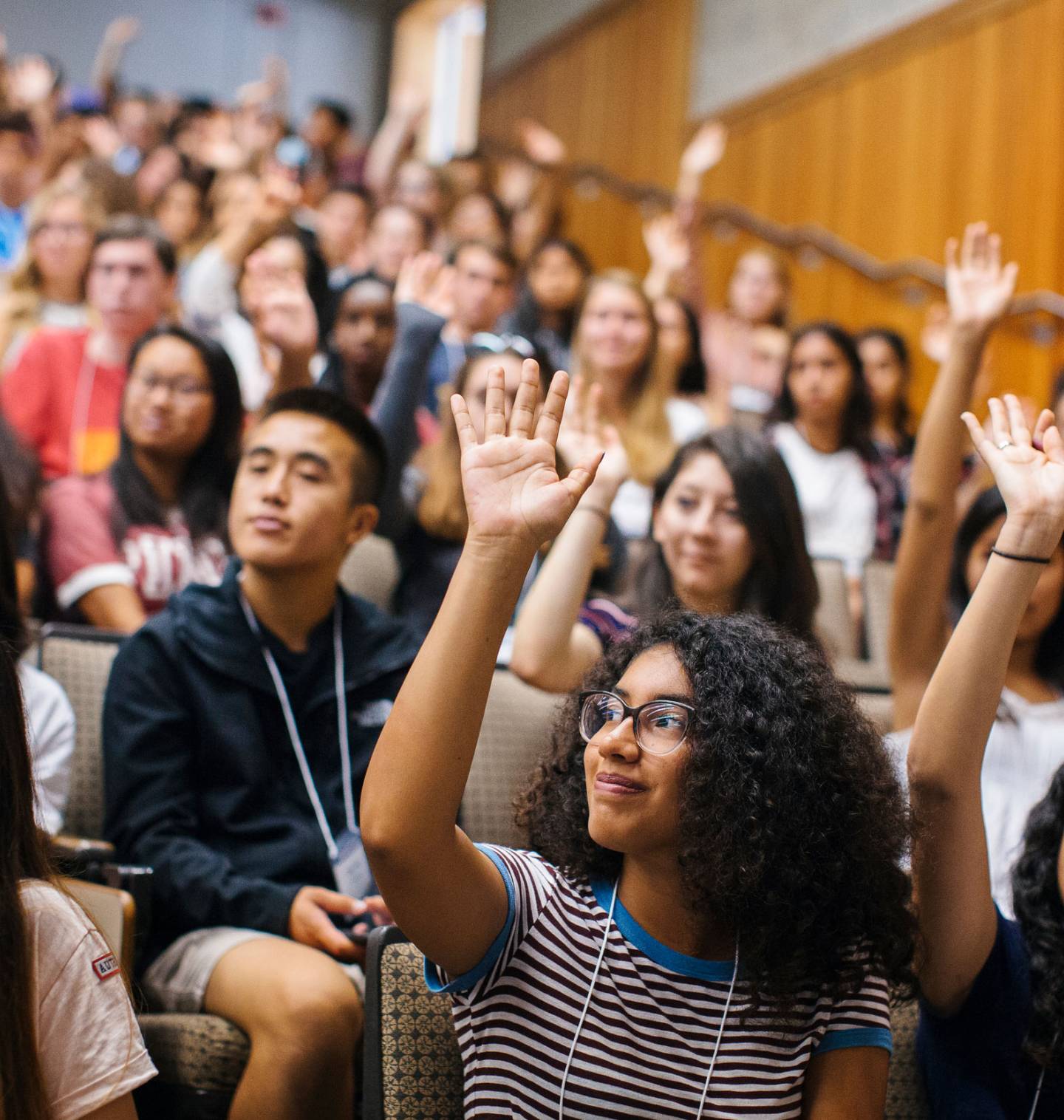 Group of students raising their hand