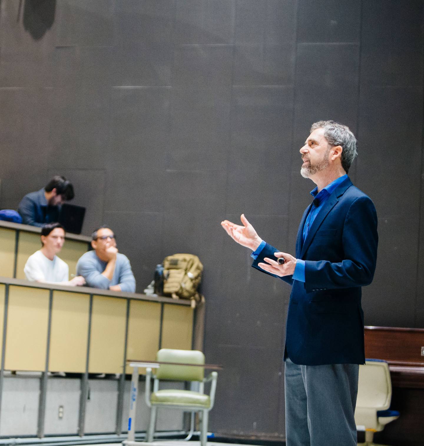 Faculty member giving a lecture in front of an audience of students