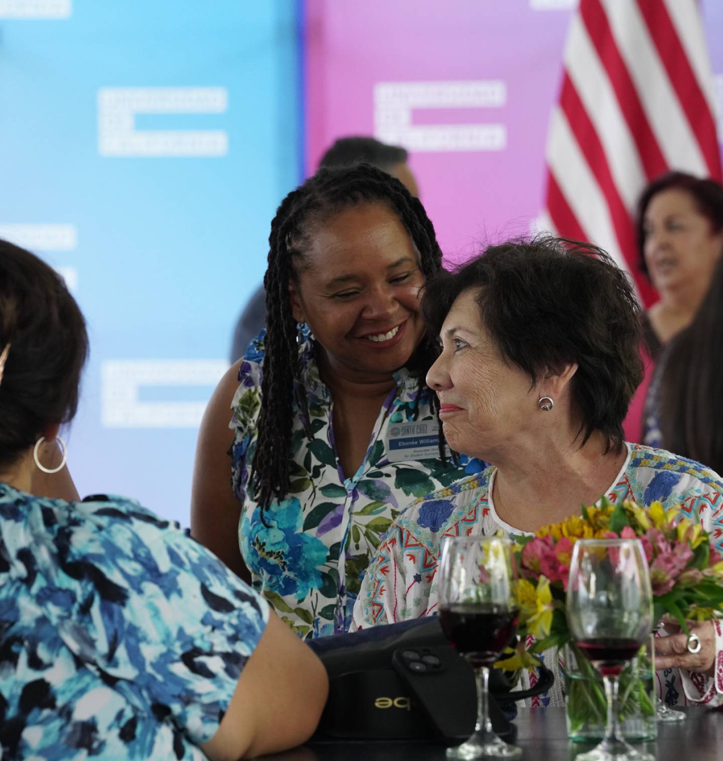 A group of women chat informally at a University of California networking event