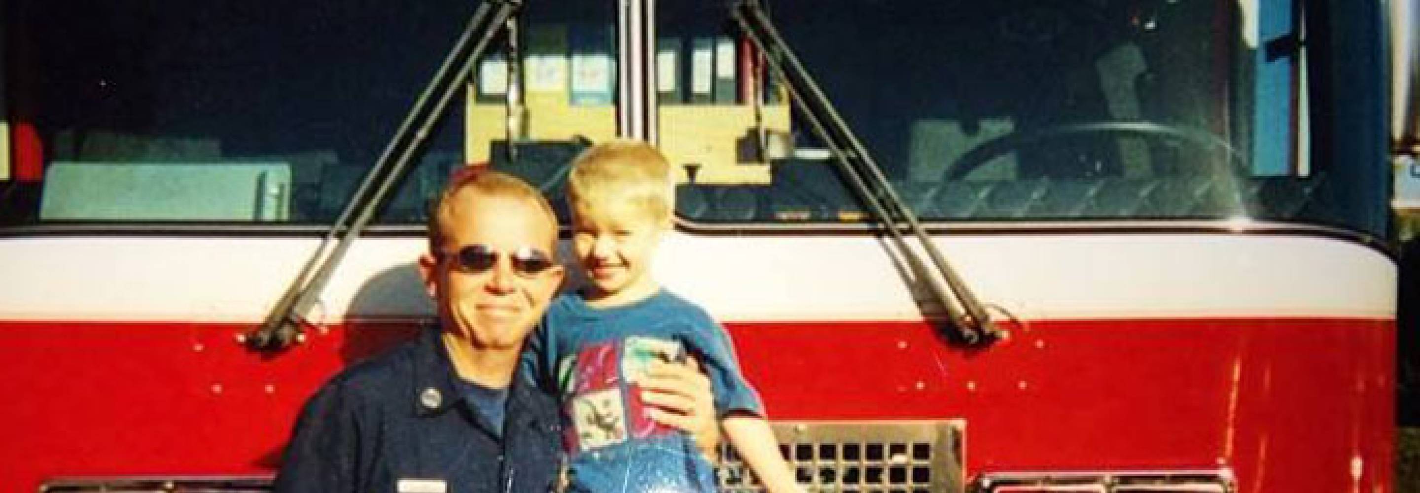 Kelly Richeson in front of fire truck with son