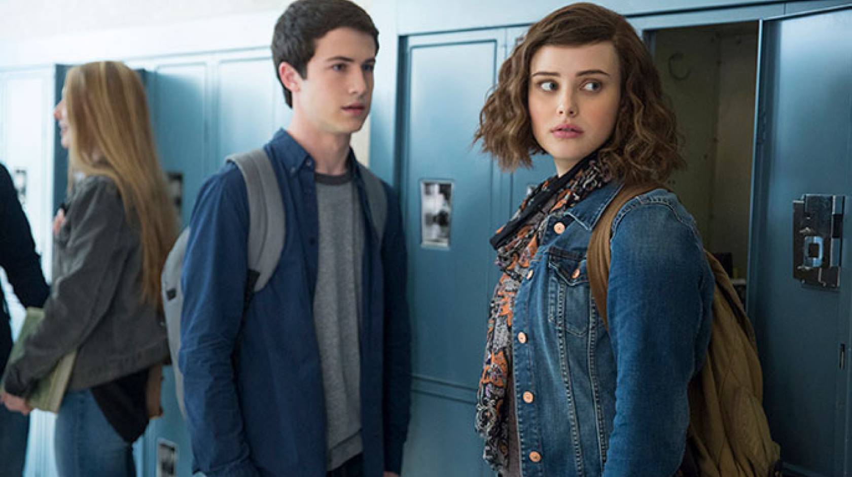 Two teens stand in front of locker in 13 Reasons Why