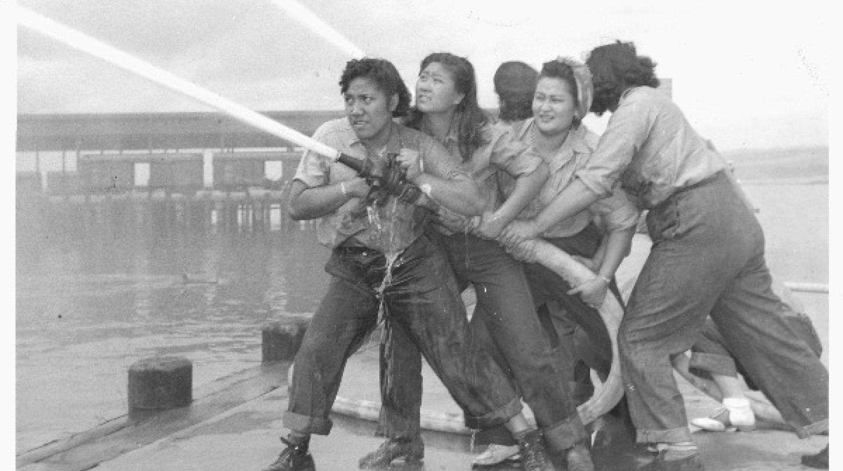 Women training with fire hose at Pearl Harbor Naval Shipyard.