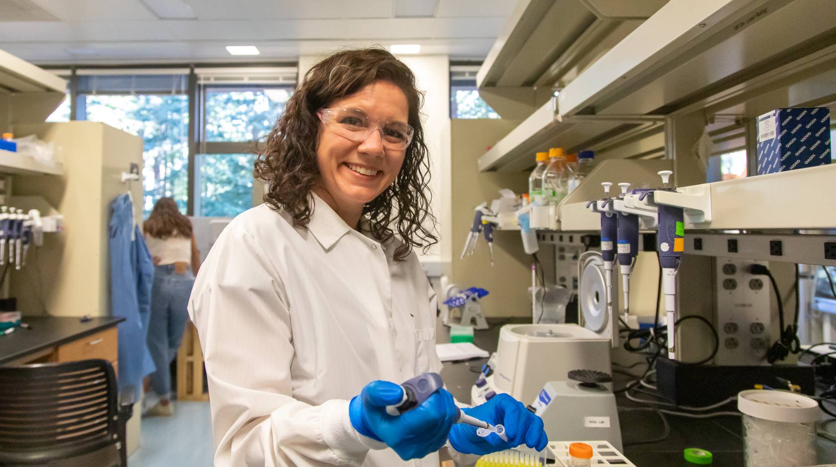 Karen Miga in the lab, smiling