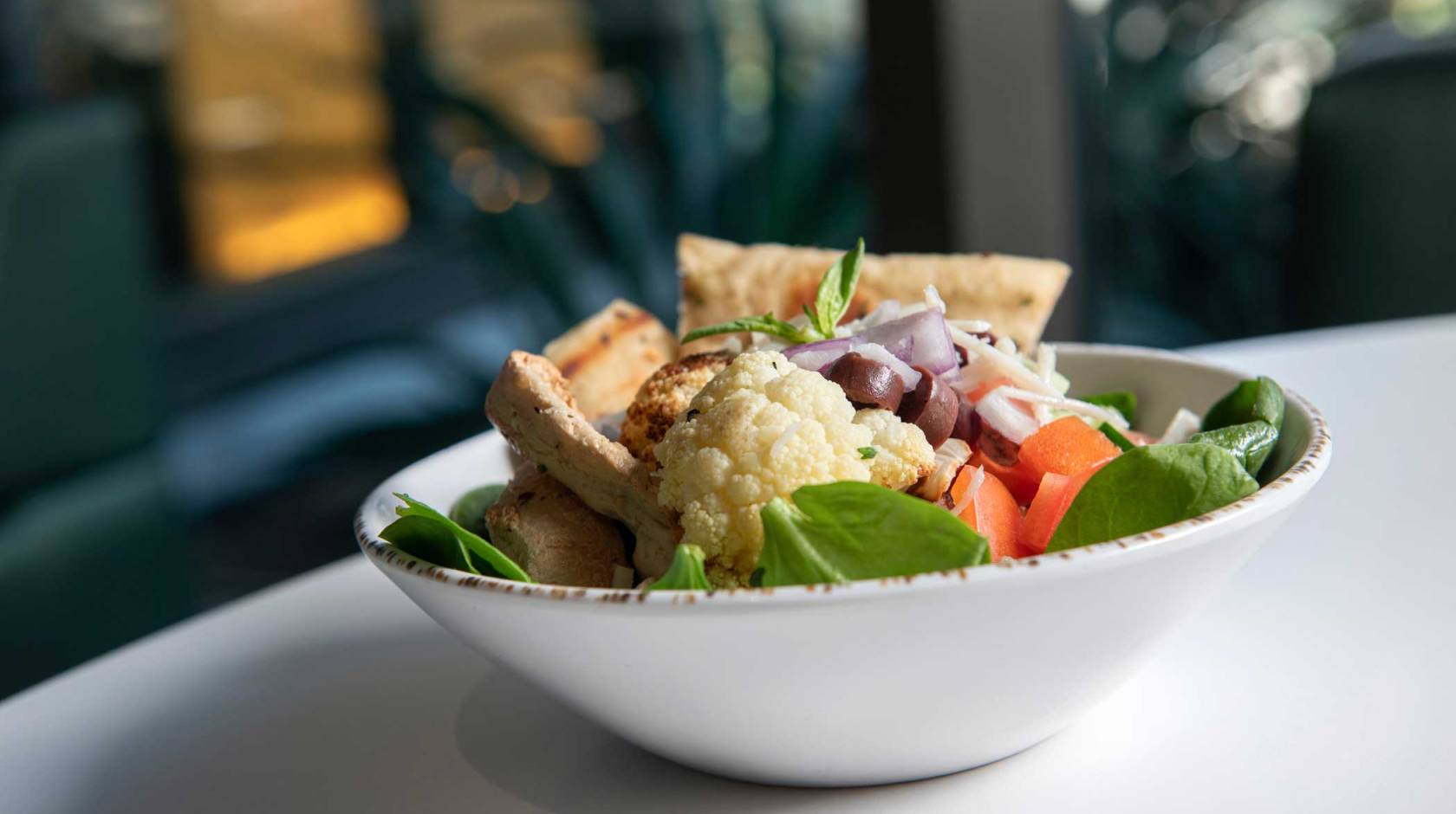 A bowl of cauliflower, spinach, tofu and other plant-based foods