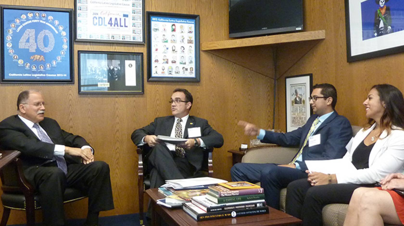 UC Riverside grad students Vicente Nunez and Jessica Diaz, along with graduate dean Joseph Childers, chatted with state Assemblyman Jose Medina about the nature of their research.