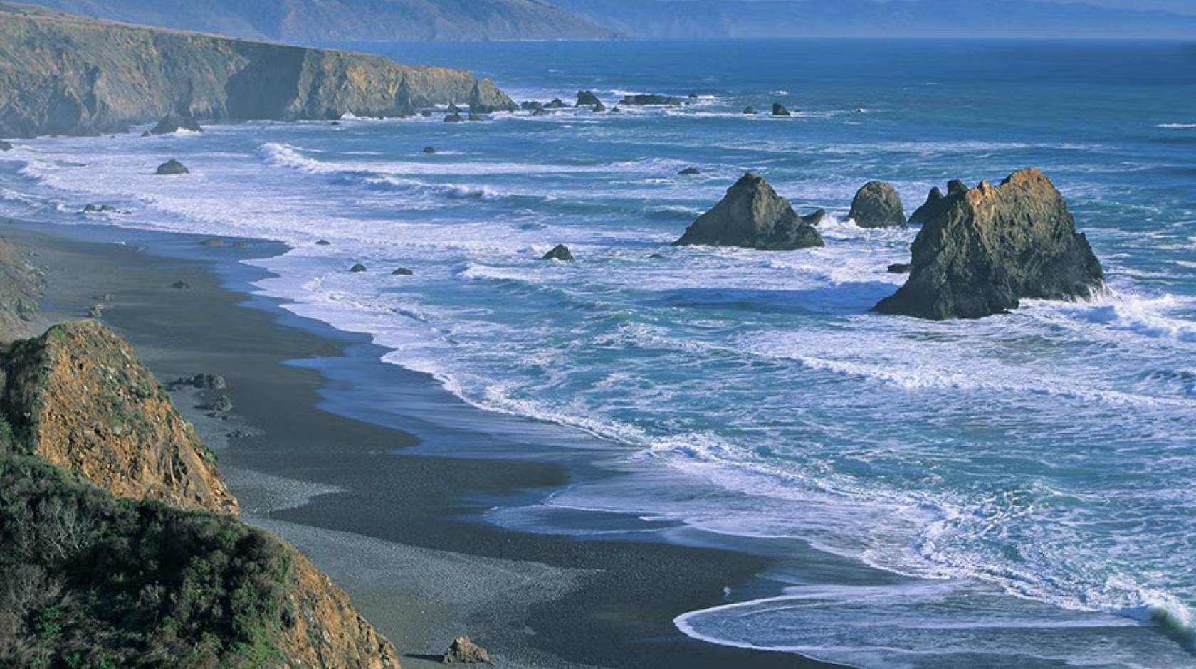 View of the California coast with large rocks in the waves