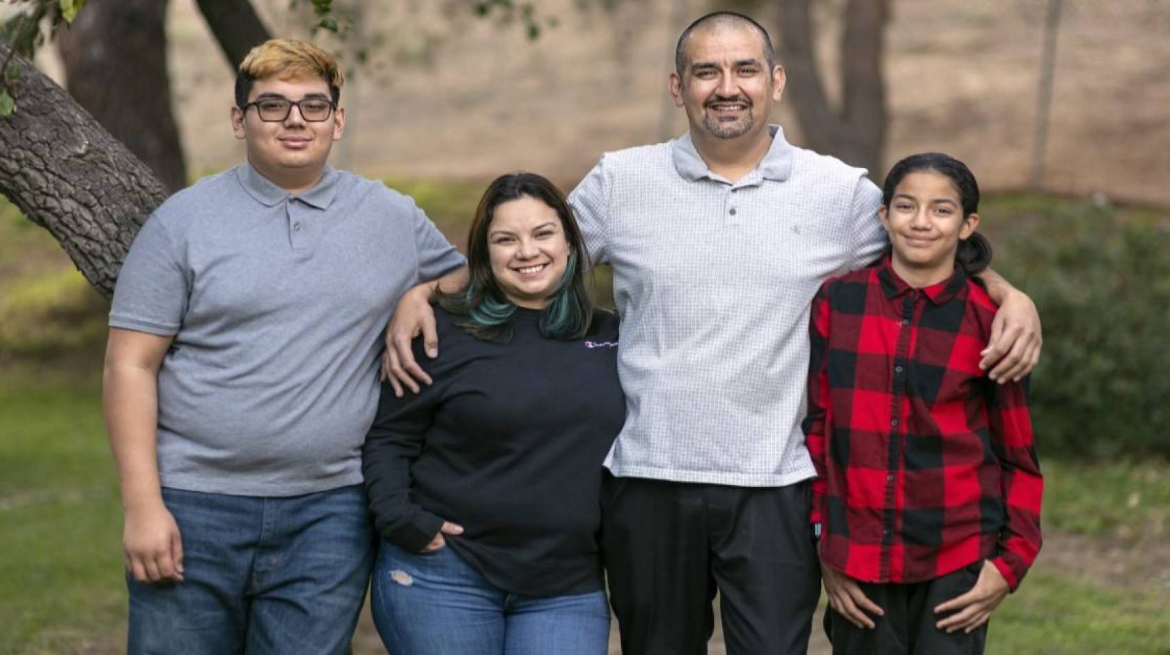 Lazaro Barajas stands with his wife, daughter and son