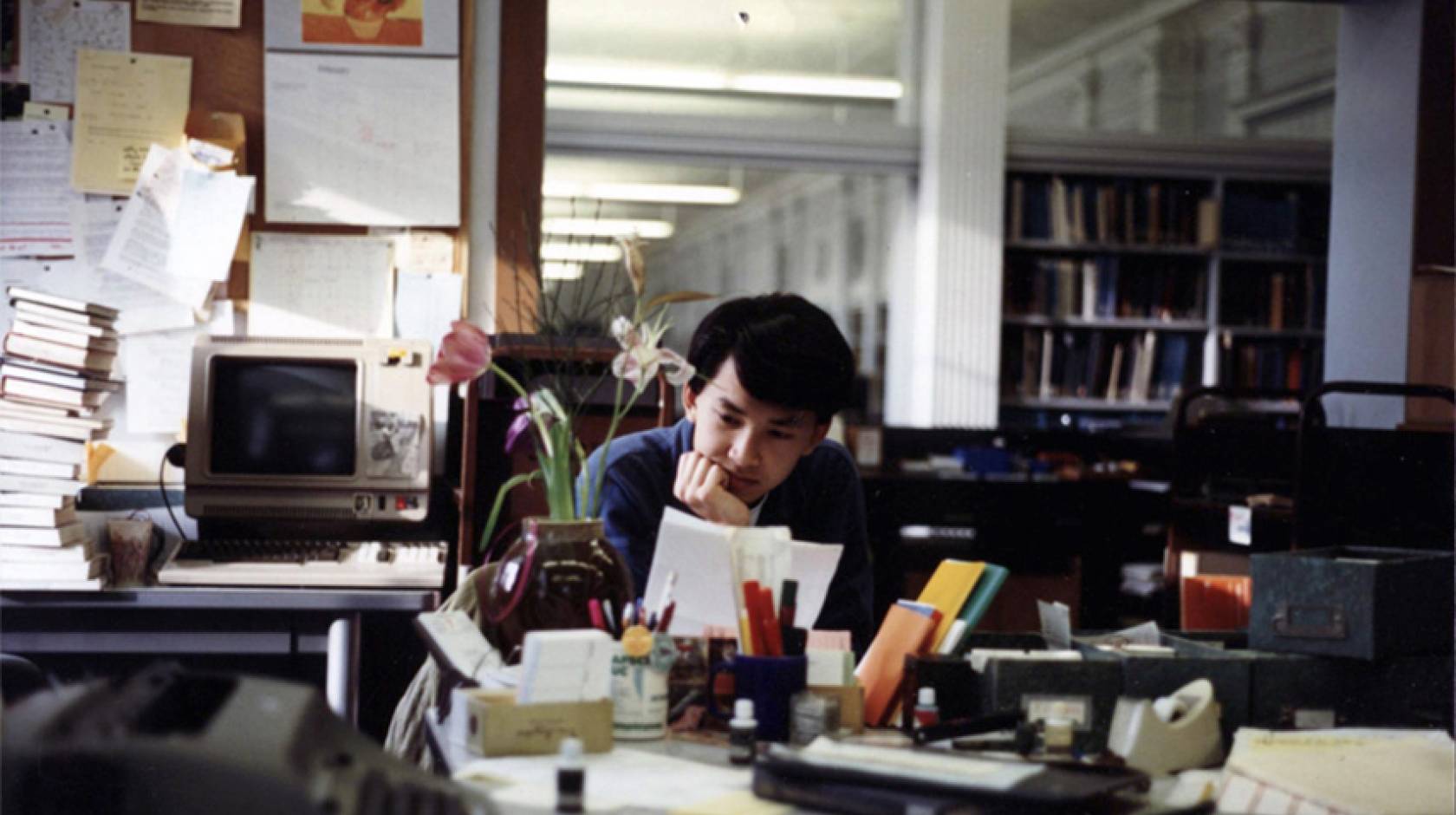 Viet Thanh Nguyen reading a paper in the library as a student at UC Berkeley