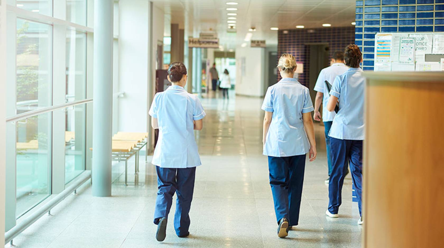 Nurses in a hospital hallway, walking away