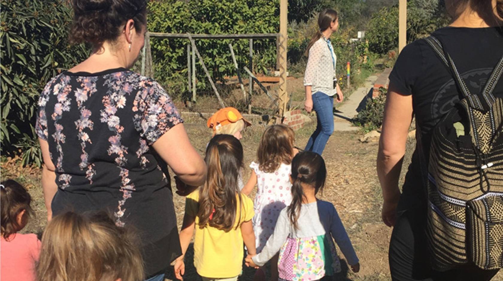 Preschoolers from the Orfalea Family Children’s Center at UCSB enter the campus Greenhouse & Garden Project for a lesson in gardening.