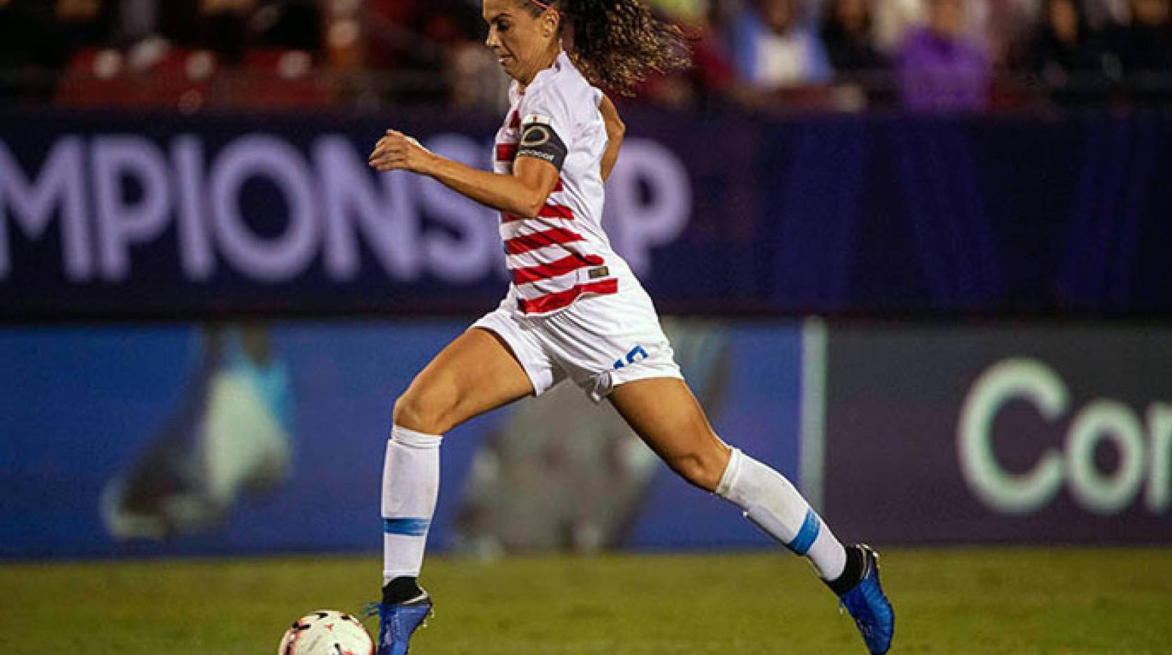 Alex Morgan dribbles during a game