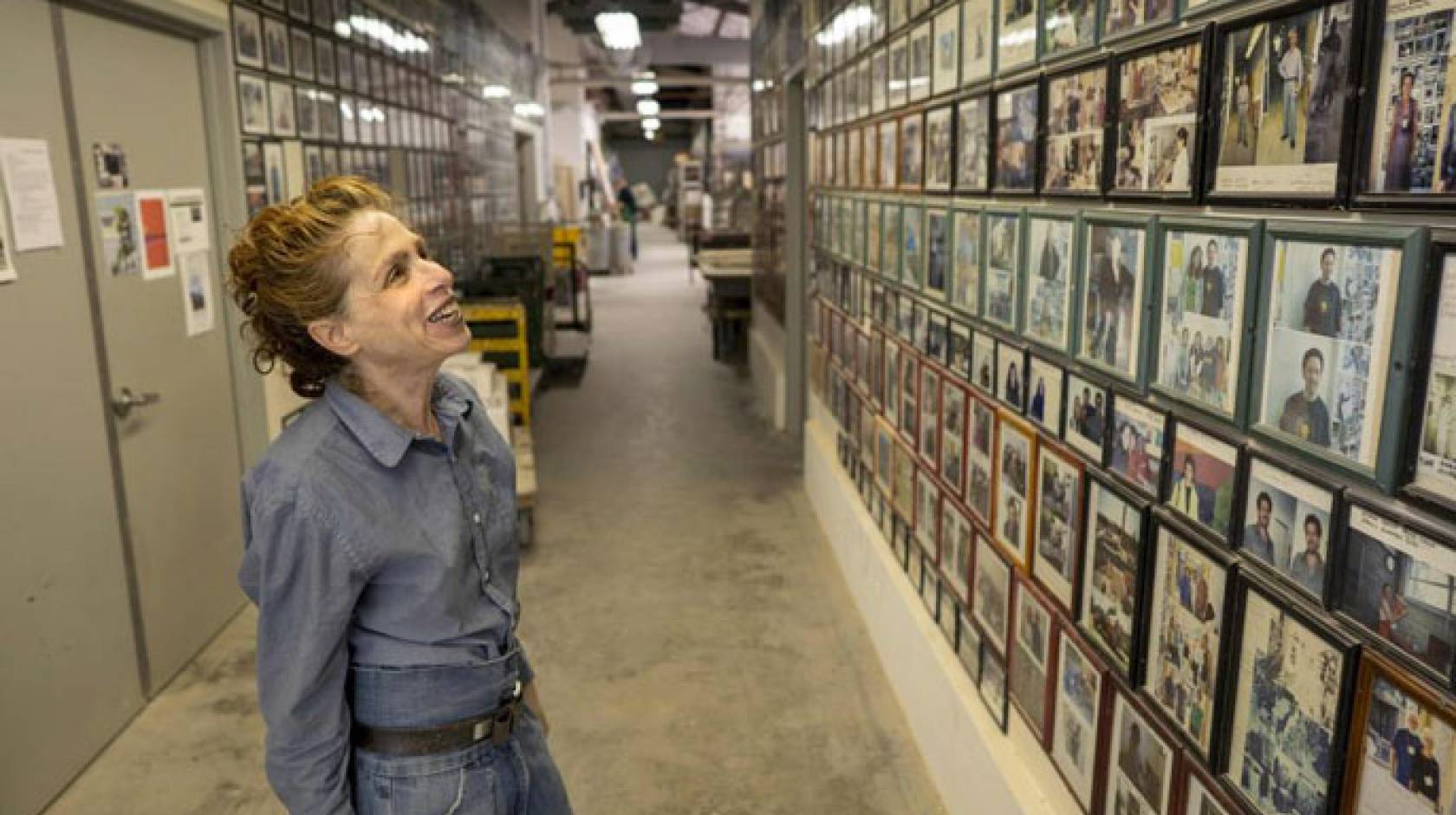 Annabeth Rosen looks at a wall of pictures