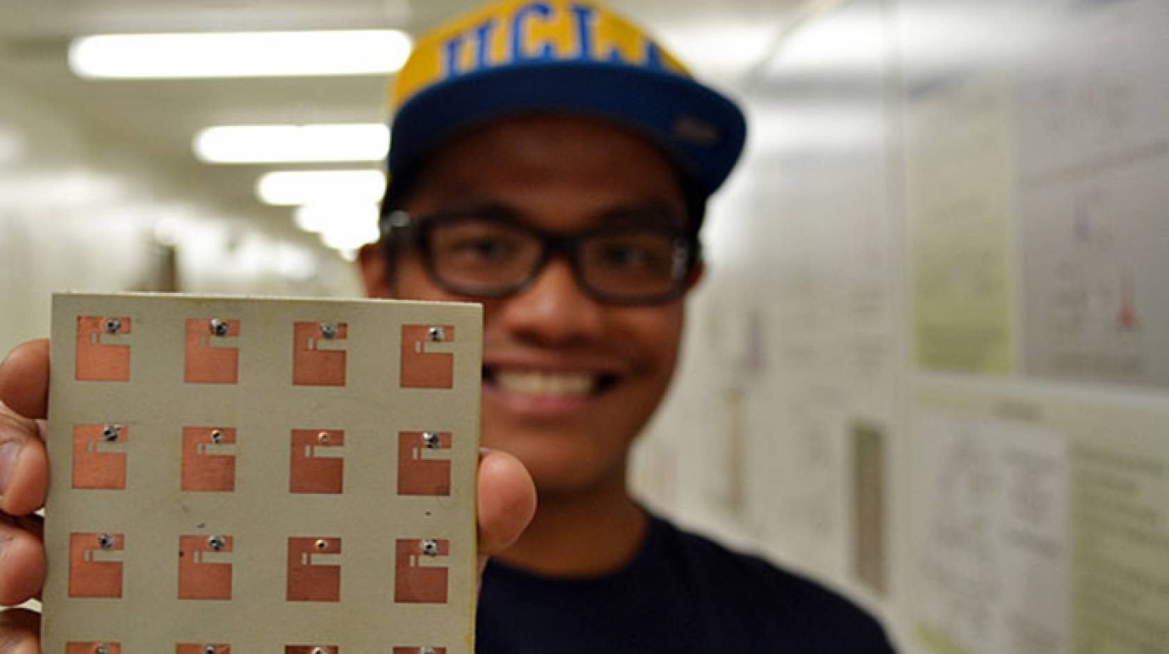 Jean Paul Santos holds antenna assembly