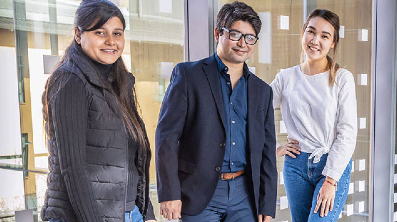 Professor Arif, center, with graduate students Laxmi Pandey, left, and Gulnar Rakhmetulla