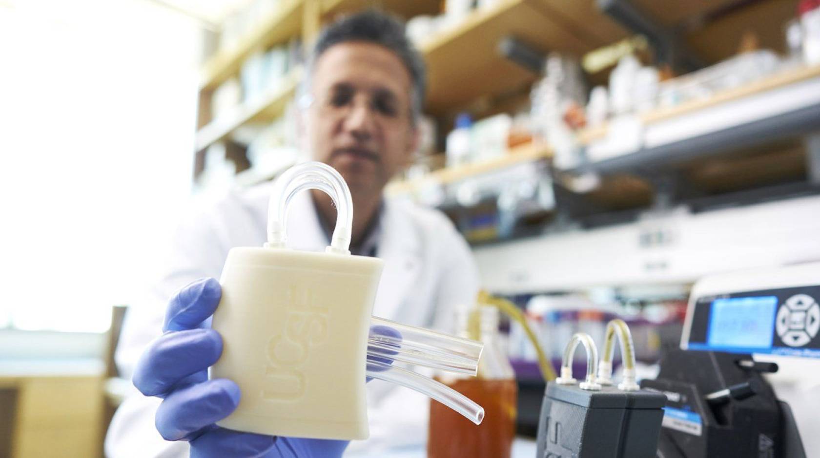 A researcher holding a piece of medical equipment