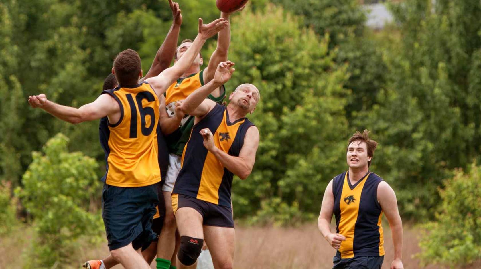 Australian football players collide over ball