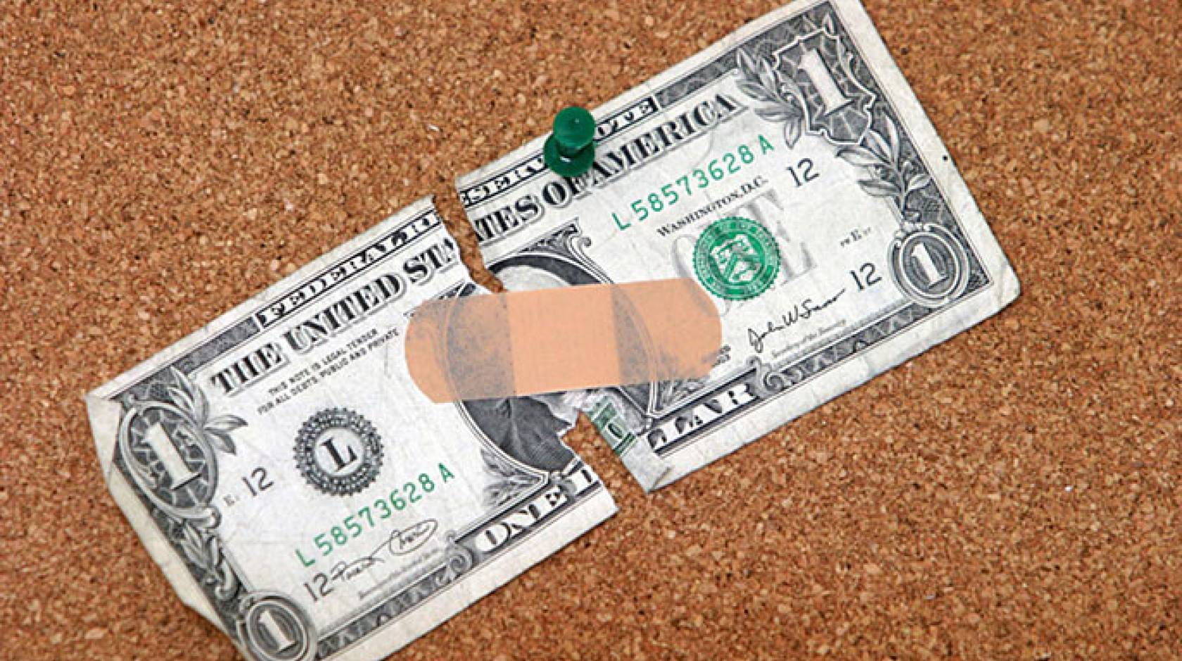 bandaged dollar (Shutterstock)