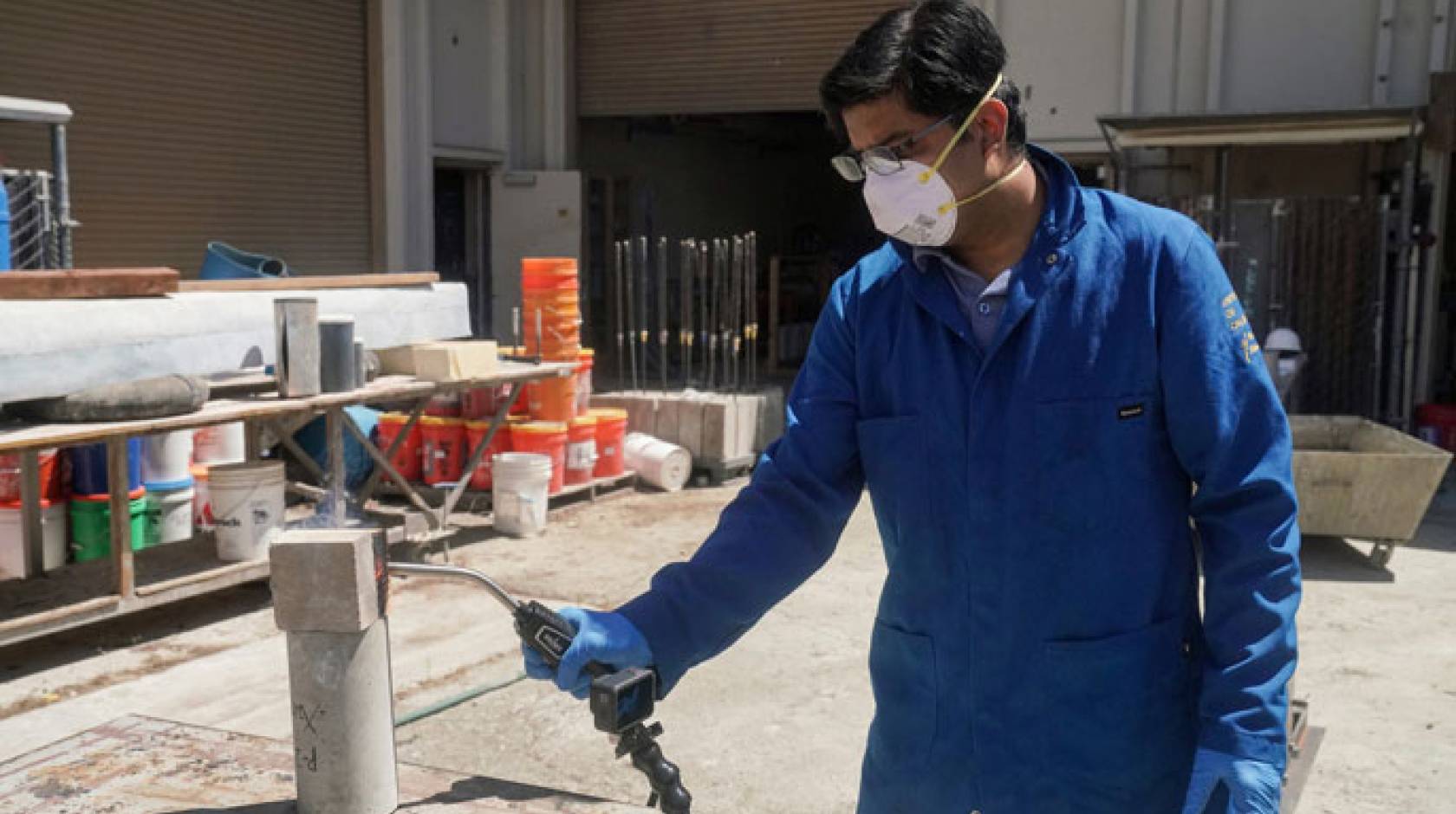 Researcher using a blow torch on a block