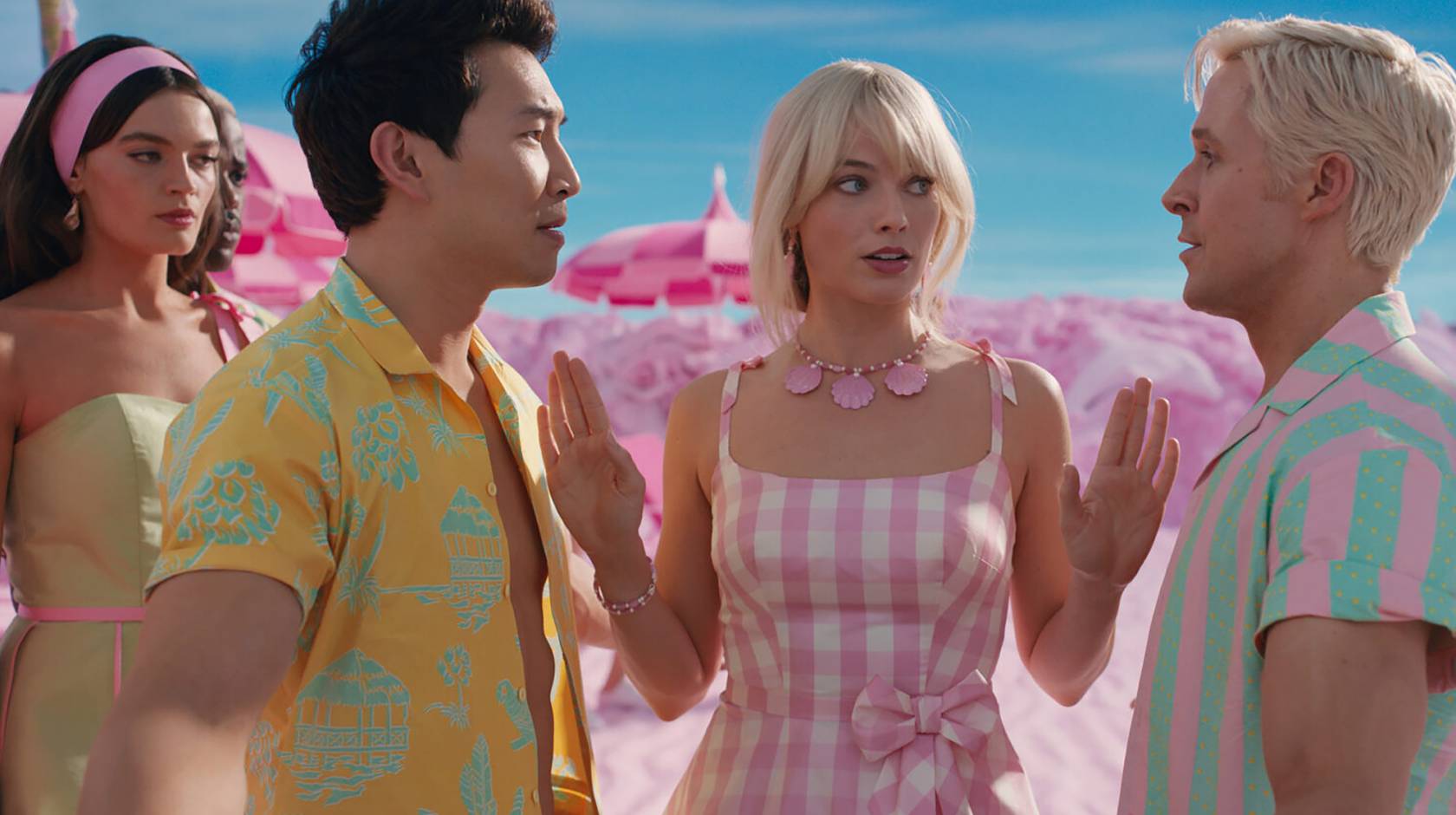 Margot Robbie as Barbie separating two Kens