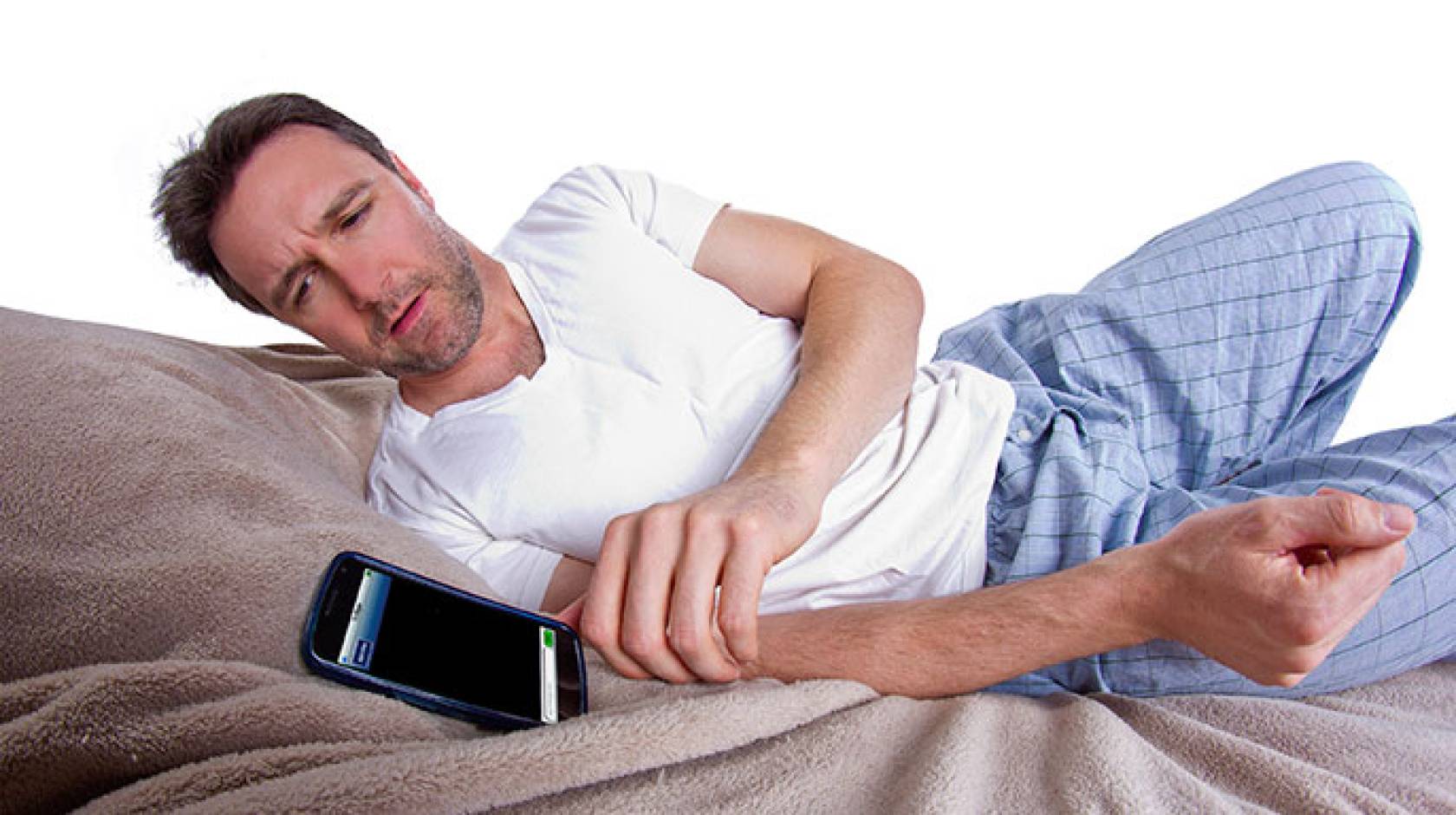 man in bed with cell phone