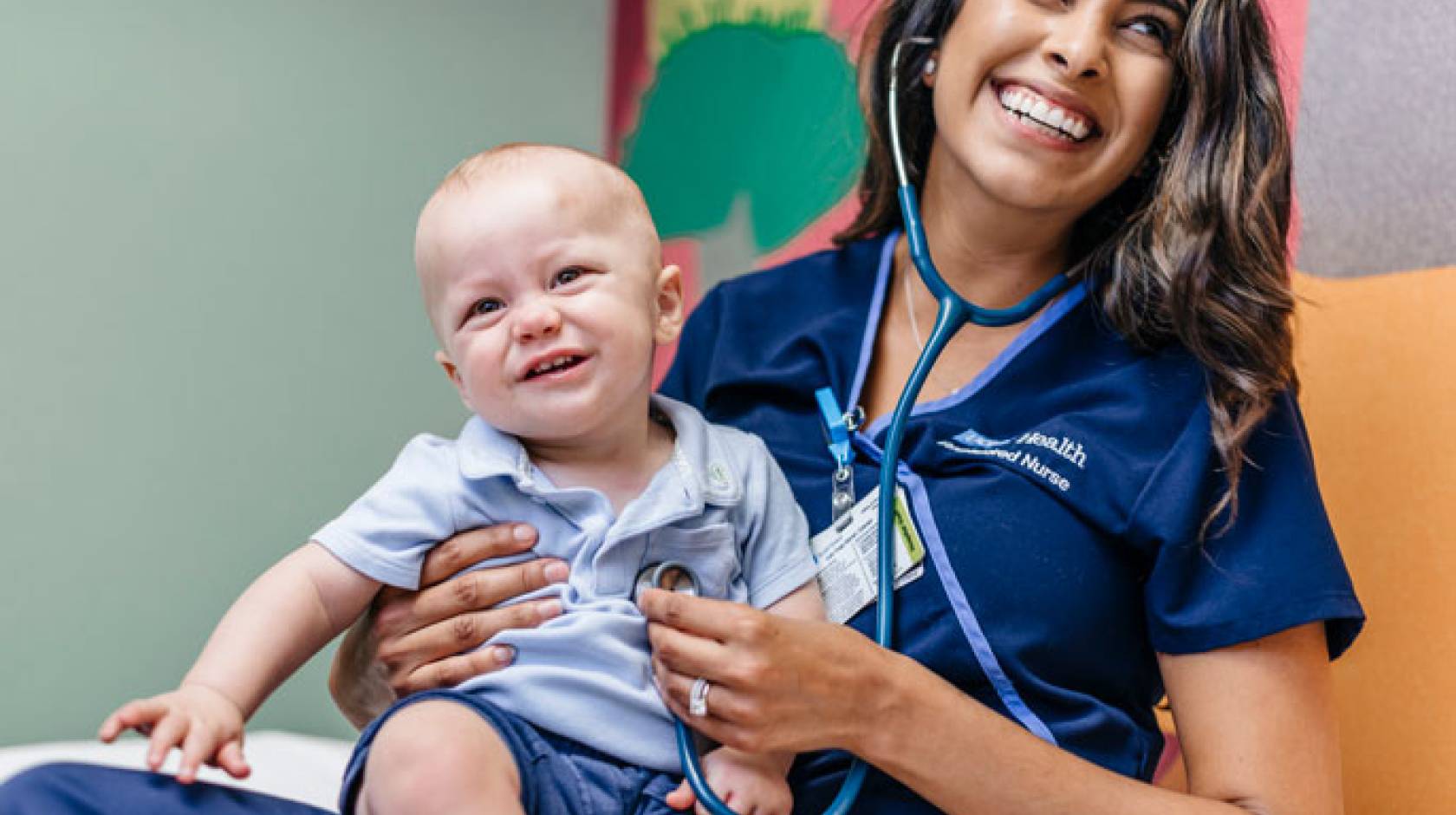 Nurse smiling with a baby