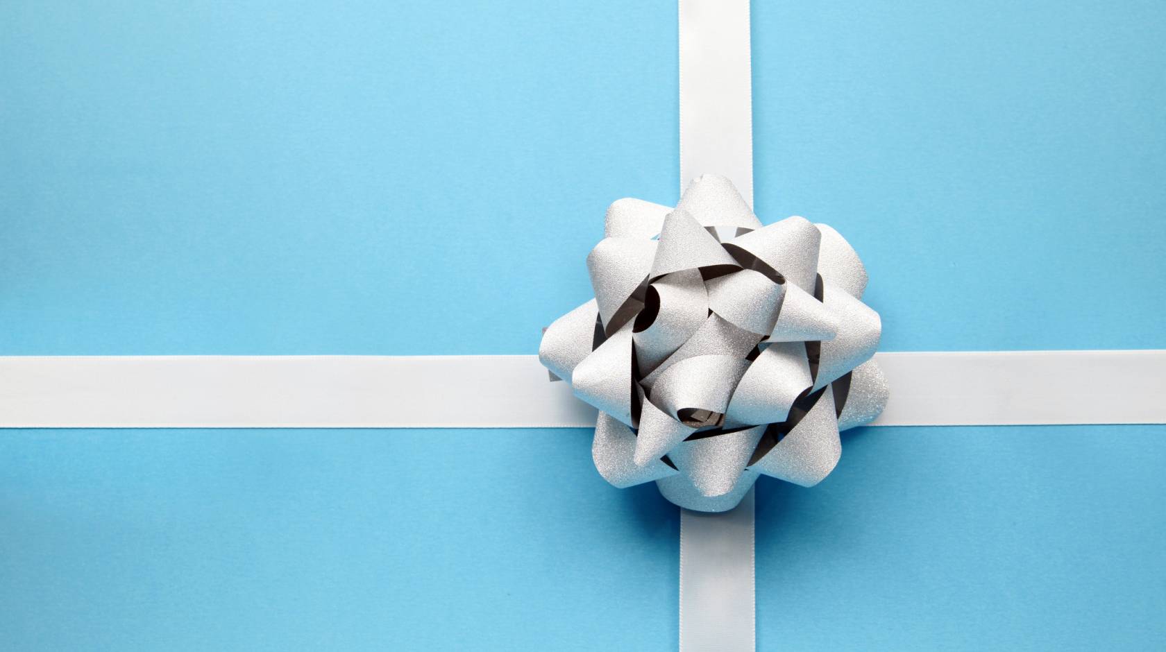 Blue present wrapping with a white bow