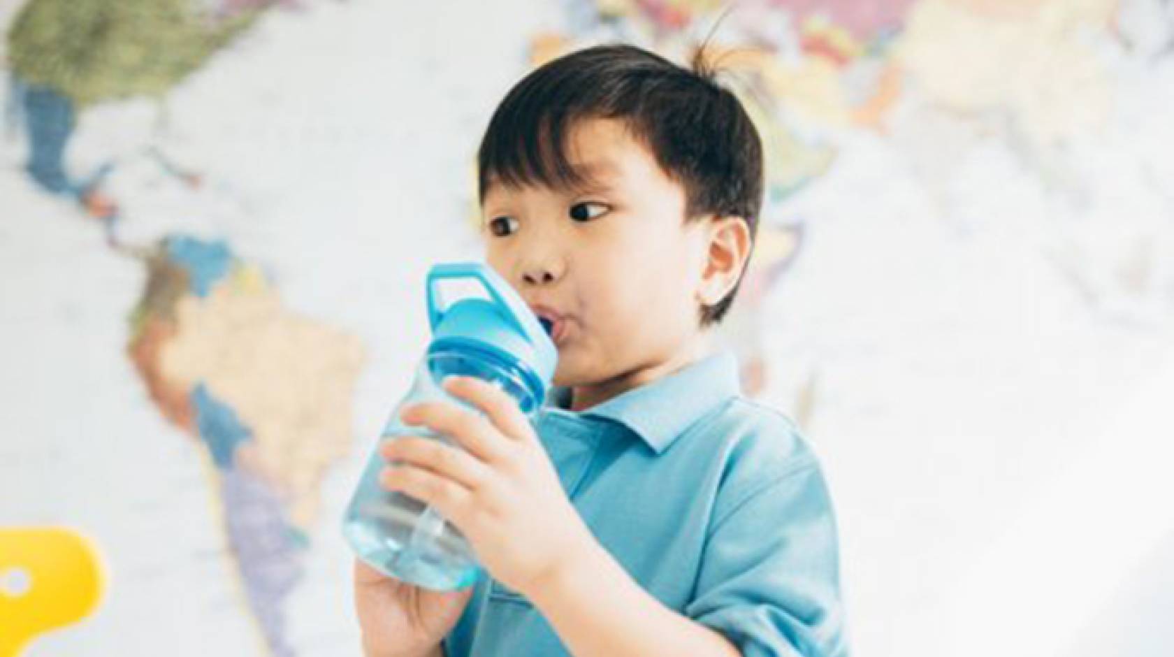 kid drinking water from fountain